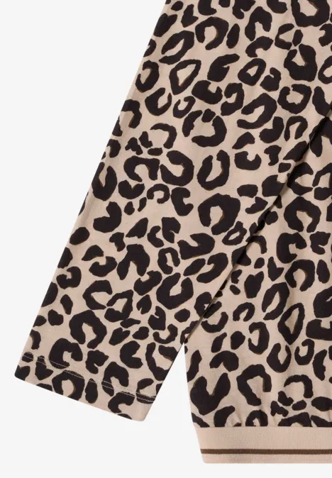 Beiger Stoff mit schwarzem Leopardenmuster.